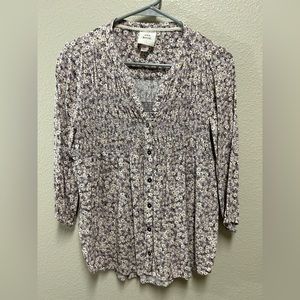 Pretty purple w/little white daisies. Buttons down front and smocking.